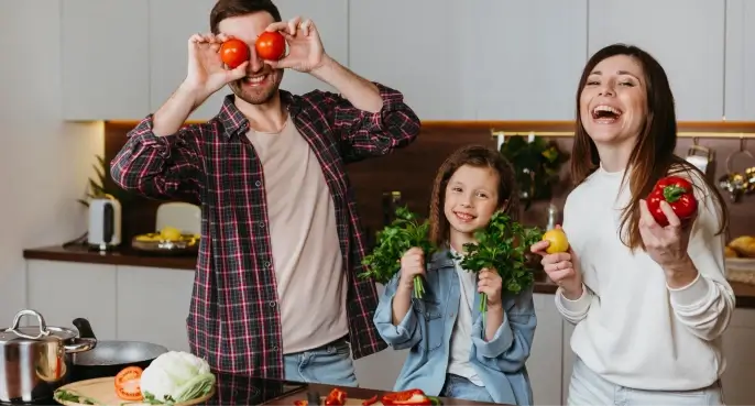 front view family having fun while preparing food in kitchen