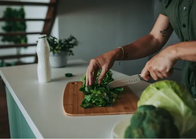 woman cutting salad